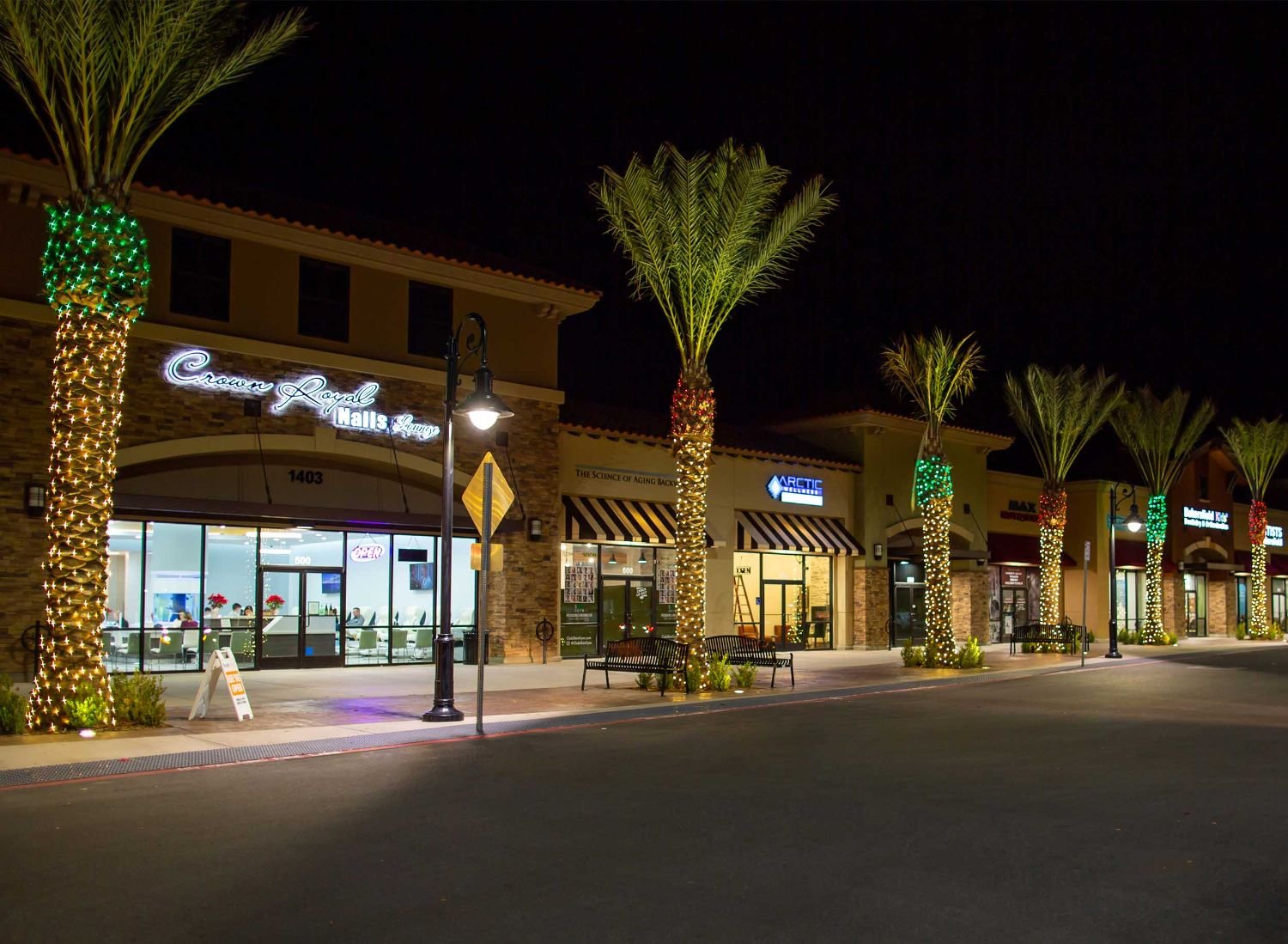 Retail center and palms in lights