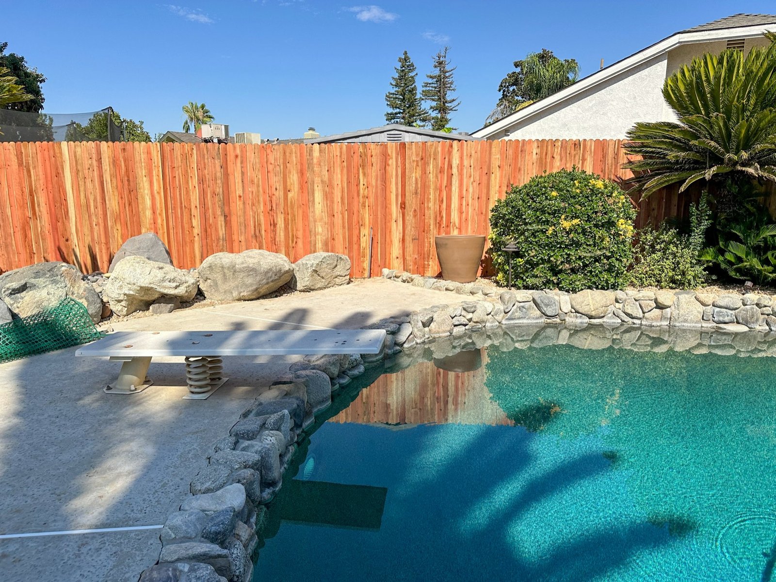 New wood privacy fence beside a Bakersfield backyard pool